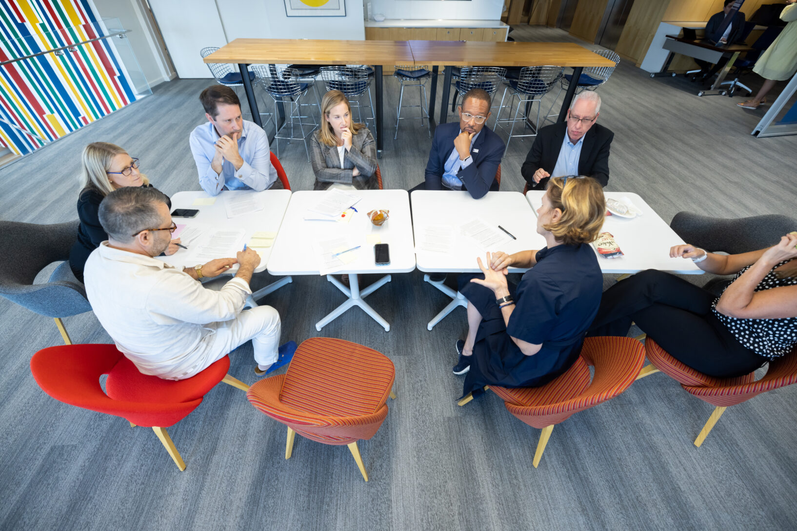 People sit in discussion around a table.