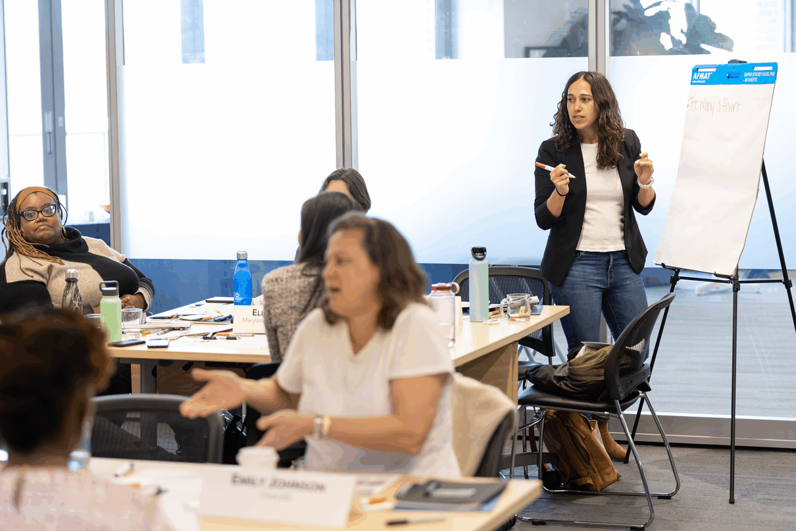 Aspen FSP researcher Sheida Elmi writes on a poster board at an event.