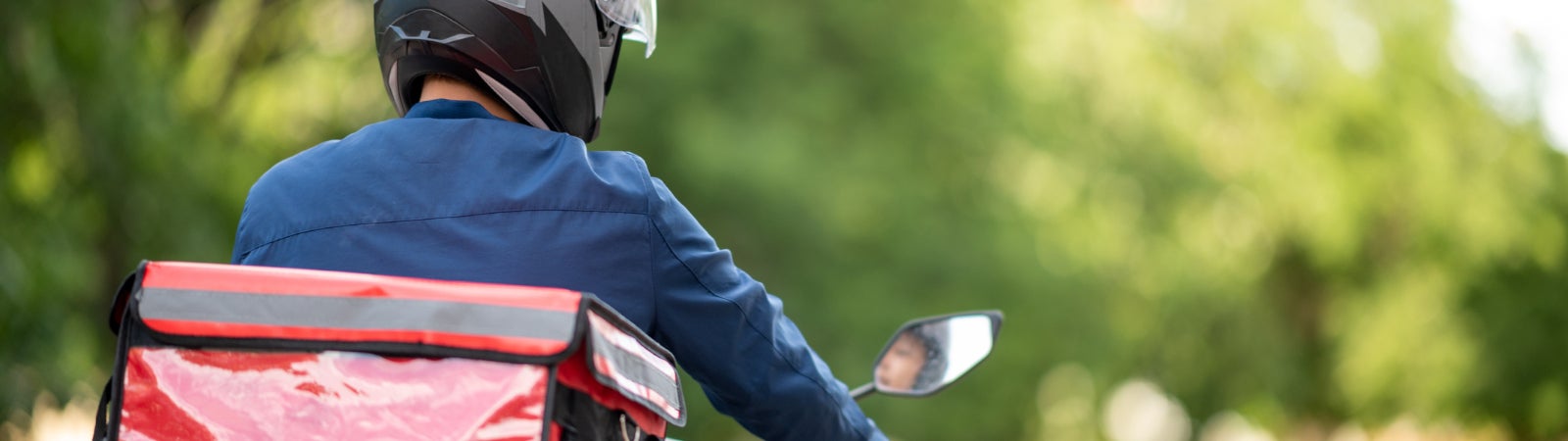 Photo of a delivery driver on a motorbike