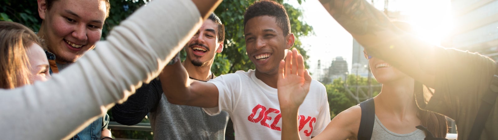 Diverse group of young people high-fiving
