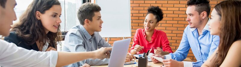 Young people meeting around a conference table