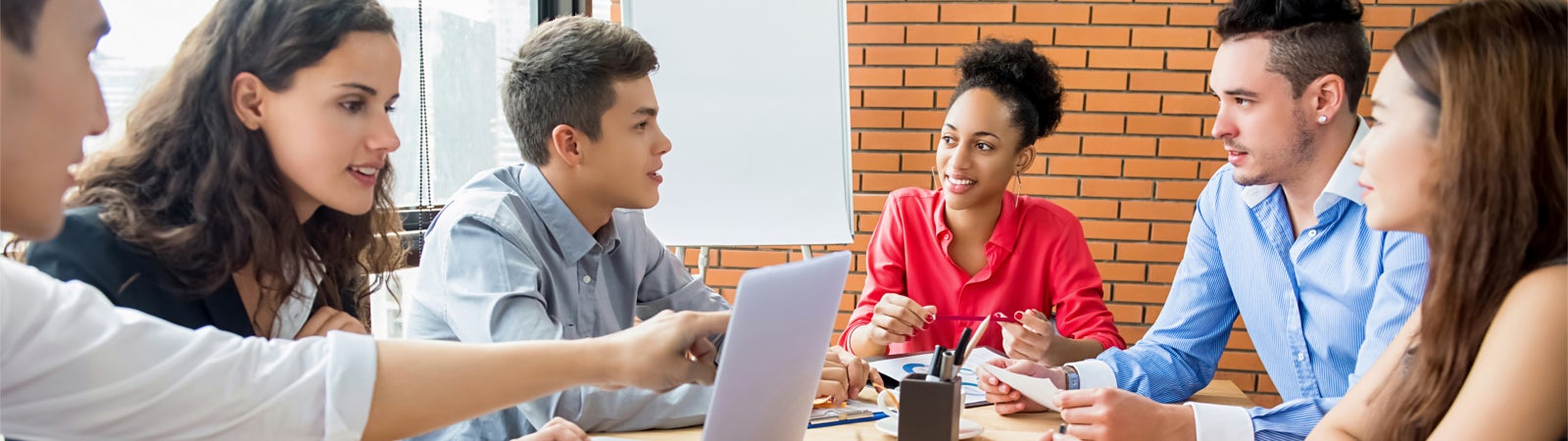 Young people meeting around a conference table