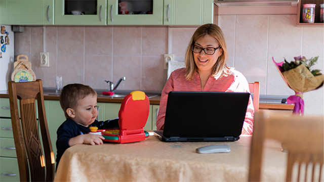 Mother and son working at kitchen table