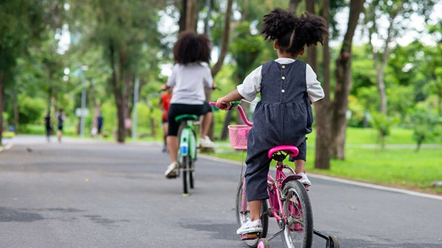 Children riding bikes in park