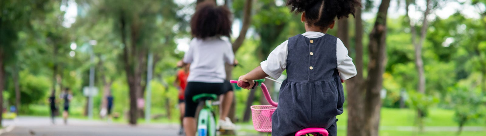Children riding bikes in park