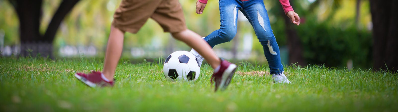 Kids playing soccer outside