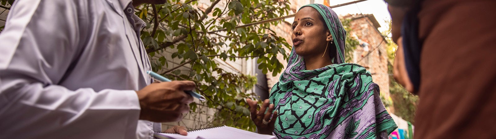 Man talking to woman and taking notes in South Asia
