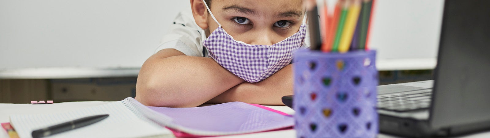 Sad school child with mask