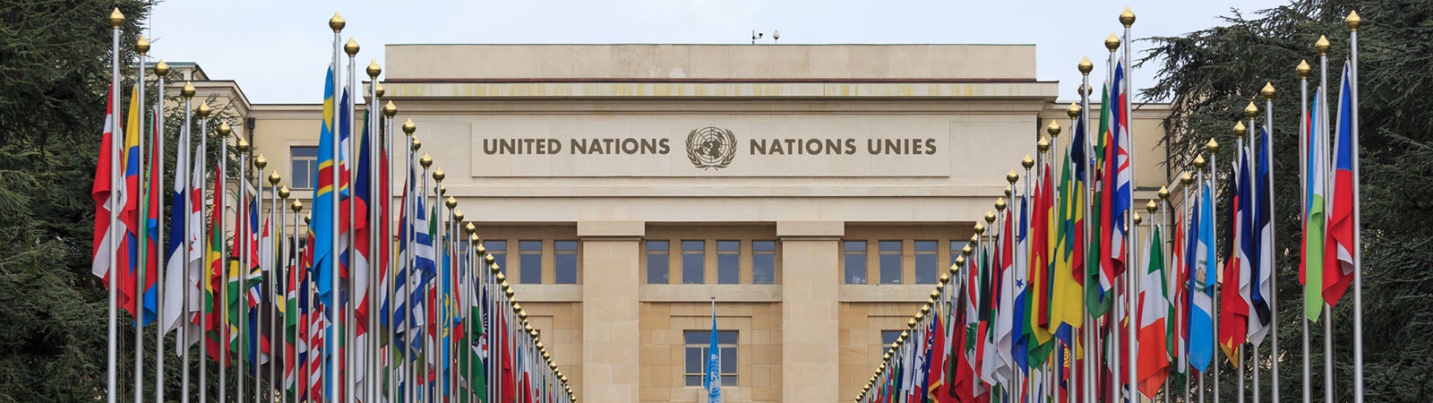 A wide image of the United Nations building, with flags from countries on either side.