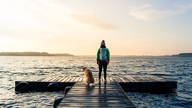Women with dog by ocean